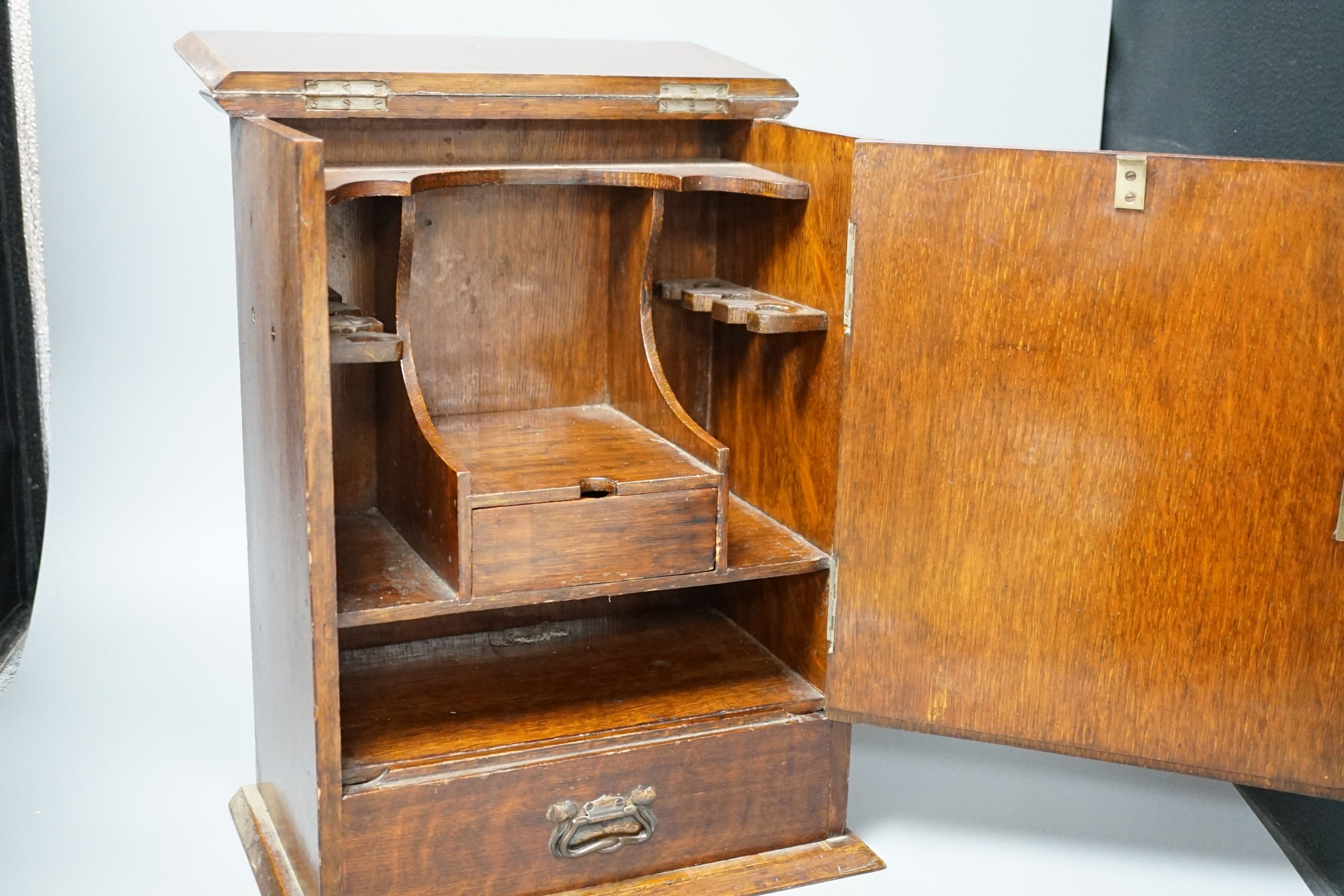 A late Victorian smokers cabinet with embossed metal panel to door and fitted interior 40cm